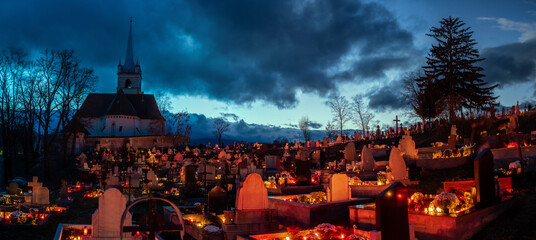 Night cemetery on All Saints' Day in Romani, Transylvania. Grave lights on All Saints' Day.


