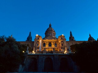 Fototapeta na wymiar National Palace in Barcelona lit up against the night sky, illuminated with a warm glow