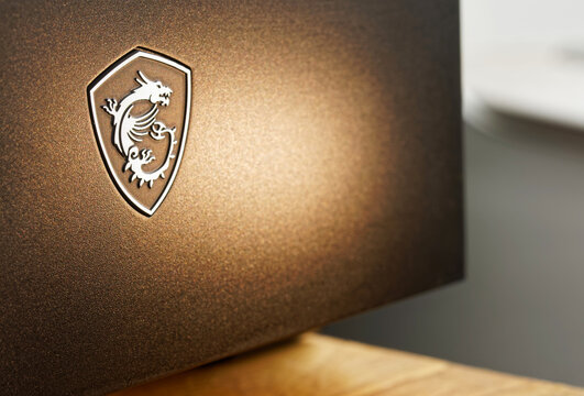 Medieval coat of arms with a dragon - the logo of the Taiwanese computer equipment company MSI - Micro-Star International Co on PC. Desktop wallpaper, 16:9. Barcelona, Spain, October 6, 2023.