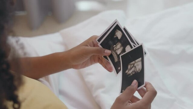 Love Captured, A Pregnant Moment with Ultrasound Image on Bed