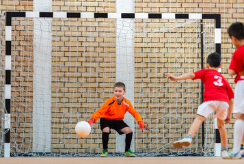  Kids playing football soccer game on sports field.