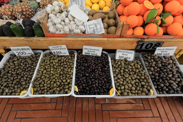 Plastic and wood boxes containing table olives and various fruits at a market stall, Pazari i Ri-New Bazaar. Tirana-Albania-007