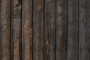 Naklejka premium Close up photo shot rustic aged brown wood texture gradient front view. Wooden planks for natural background with vertical lines. Log cabin material - interior exterior design in traditional houses.