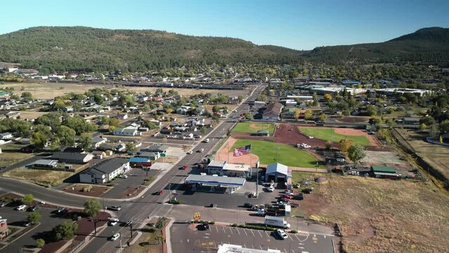 Aerial pull away from small historic tourist town of Williams Arizona in fall