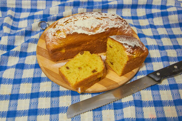 cake cut on a wooden board,homemade sweet cupcake on a table with a blue tablecloth