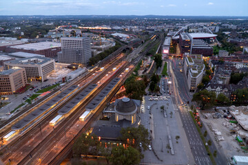 evening aerial view of Cologne station Koln Messe Deutz and illuminated railway tracks, seen from the Cologne Triangle
