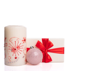 Christmas set on a white background. Candle, gift box with red ribbon and toy.