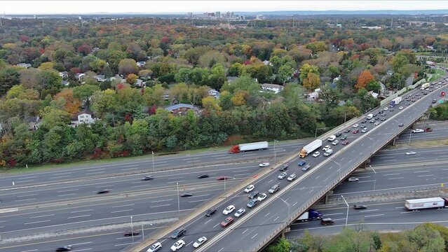 This aerial view American freeway I-95 NJ Turnpike with heavy traffic moving quickly from left to right