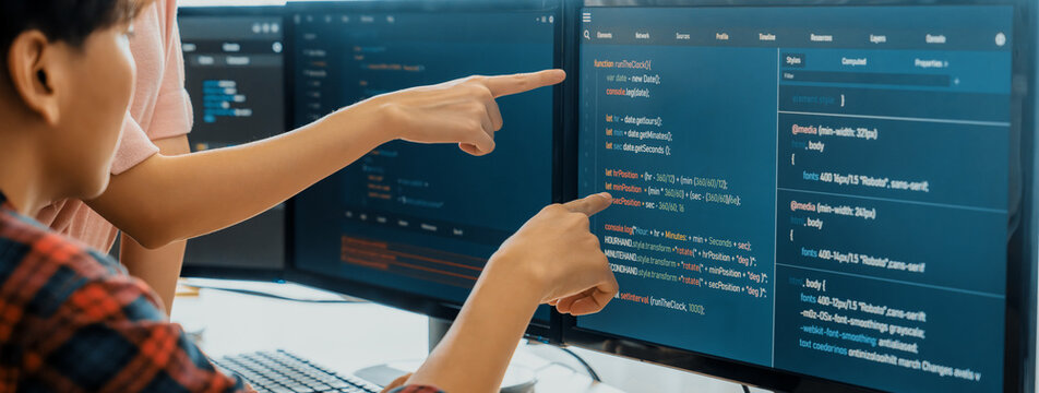 Cropped image of professional programer team collaboration discuss about web coding while coworker point java script displayed on computer at modern company office. Closeup. Burgeoning.