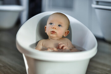 Bathing a newborn in a baby bath