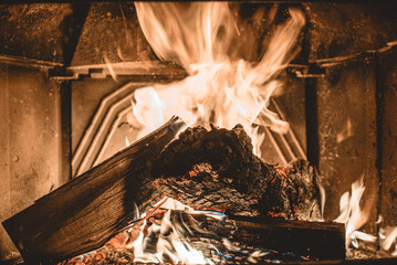 Fireplace burning. Warm cozy burning fire in a brick fireplace close up. Cozy background