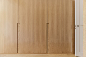 Frontal image of a bedroom hallway covered with built-in light oak wood cabinets with integrated...