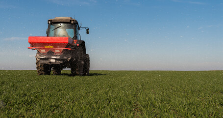  tractor fertilizing in field