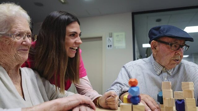 Nurse and old people smiling while playing skill games