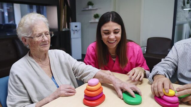 Happy nurse and old people interacting in a nursing home