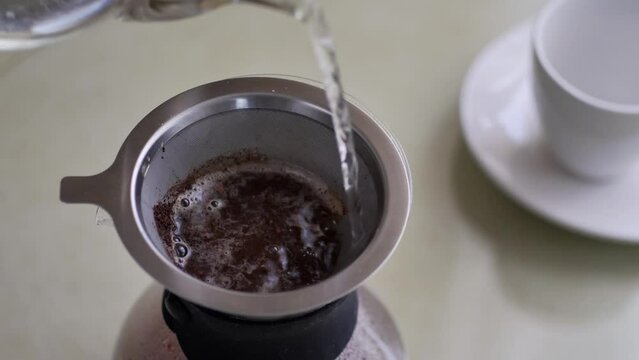 Preparing filter coffee pouring hot water