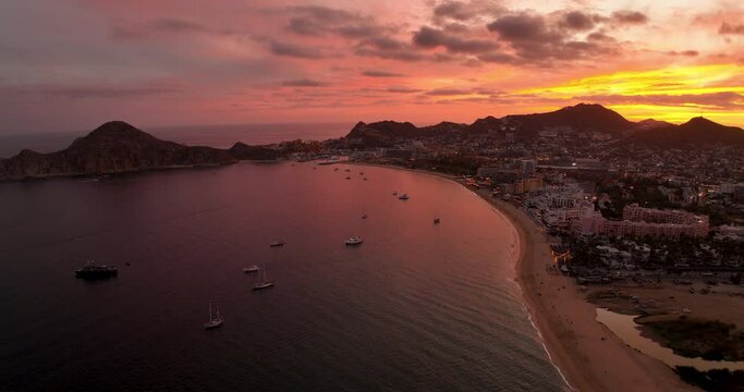 Nautical Morning Crimson Sunrise and Luxury Yachts in Cabo Bay