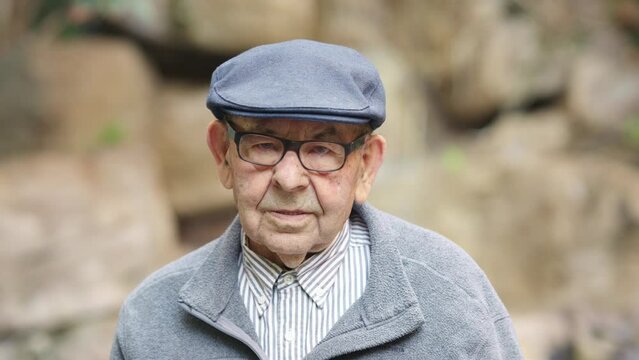 Old man wearing beret smiling at camera