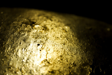 Gold gradient texture. selective focus. Gold leafe background. Fade to black.