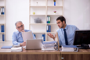 Two male colleagues working in the office