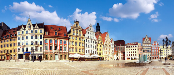 Panoramic image of Market Square in Wroclaw, Poland, Eastern Europe, on a bright day with clouds. Wroclaw is a historical capital of Silesia. Panoramic banner image. - obrazy, fototapety, plakaty