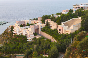 Obraz premium Athina Resort Palace Hotel. View of Agia Pelagia resort in the mountains of Crete in Greece at sunset. Mades, Ligaria. 