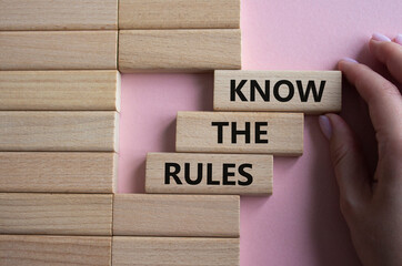 Know the rules symbol. Wooden blocks with words Know the rules. Beautiful pink background....