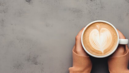 two hands of woman holding cup of coffee with latte ,top view with copy space grey  background - obrazy, fototapety, plakaty