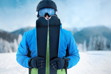 Portrait of a skier in the ski resort on the background of mountains and blue sky, Bukovel. Ski...