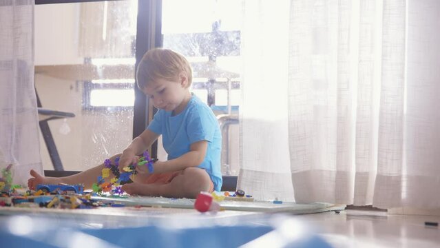 A Playful Moment: A Little Boy's Joyful Exploration of Toys at Home