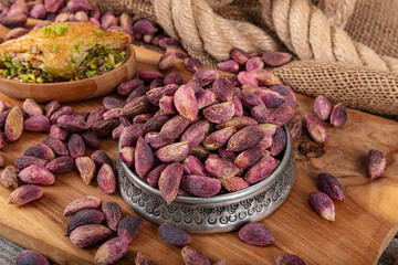 Fresh pistachios in copper bowl on wooden rustic background, wonderful peanut composition for...