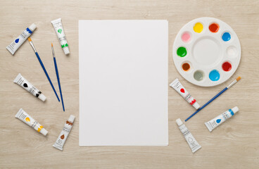 Painting tools on wooden background, top, view © Liami