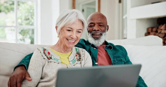 Old couple on couch with laptop, smile and relax with love, interracial marriage and online bonding in home. Computer, streaming website and happy people, senior man and woman on sofa in living room.