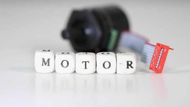 Close up view of small electrical motor with motor text on the blocks, moving focus gradually.