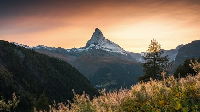 Golden sunset over Matterhorn, Iconic mountain peak and meadow in rural scene at Zermatt, Switzerland
