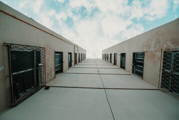 Low-angle of exterior view of a tall, multi-story building with a blue sky in the background