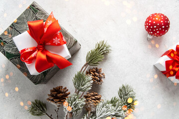 Merry Christmas and Happy Holidays greeting card, frame, banner. New Year. Noel. Christmas gifts on light background. Winter xmas holiday theme.