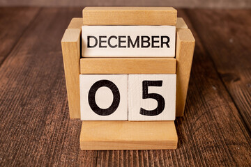 Cube shape calendar for December 05 on wooden surface with empty space for text, new year Wooden...