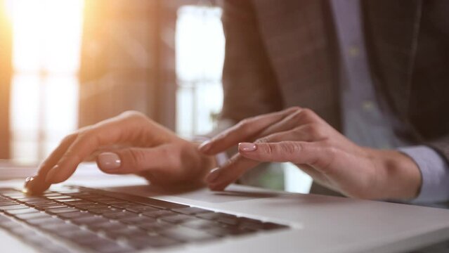 Hands of a man typing fast on a computer keyboard