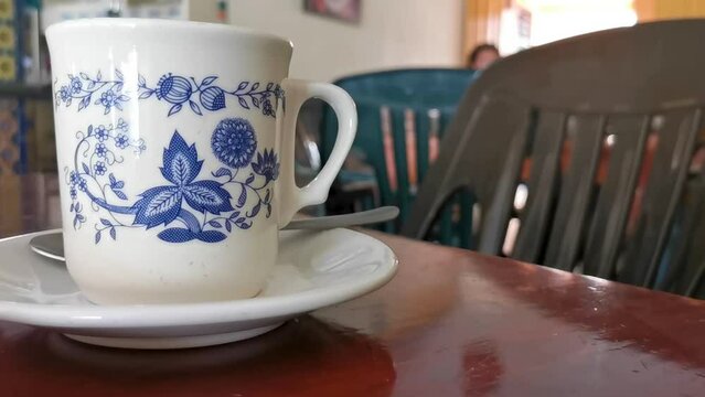 Blue white cup pot with black coffee wooden table Mexico.