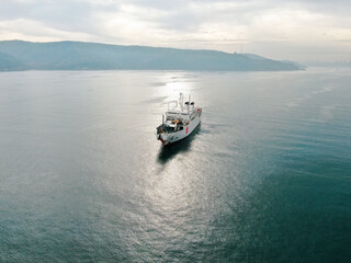 Aerial view of freight ship with cargo containers. 