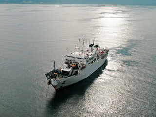Aerial view of freight ship with cargo containers. 