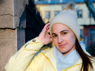 Young woman in yellow jacket in early spring in the city