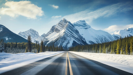 Winter highway leading to snowy mountains. Road trip in winter season. Beautiful landscape with mountain ranges