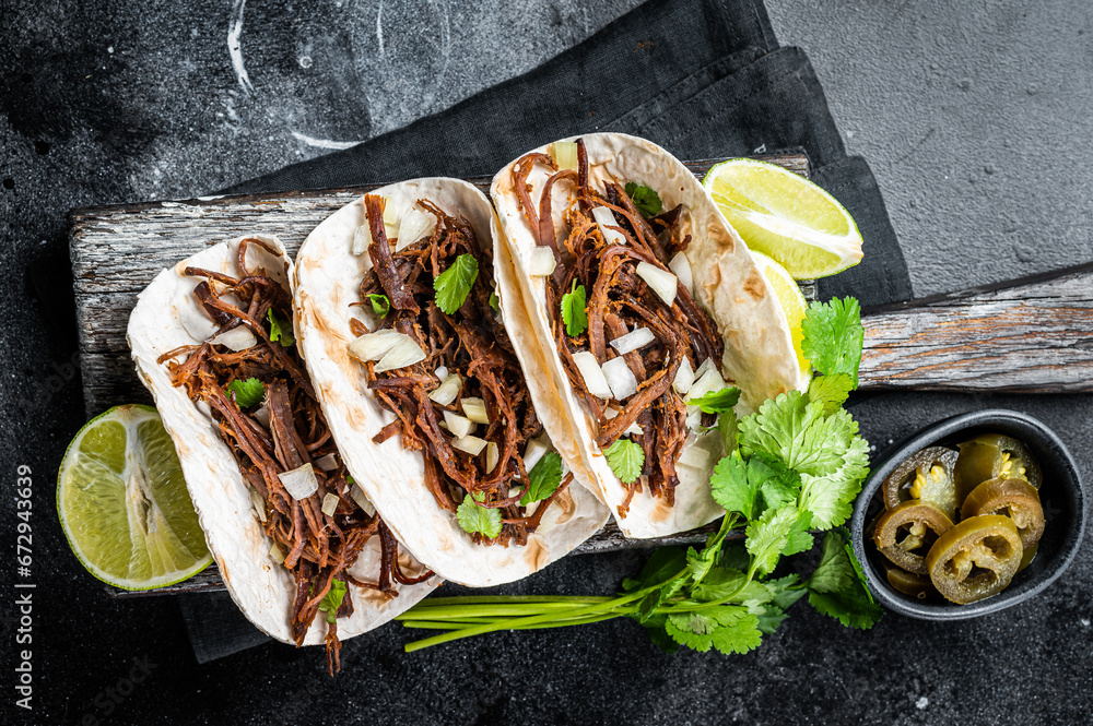 Wall mural Pork carnitas tacos on corn tortillas with onion and lime. Black background. Top view - Wall murals