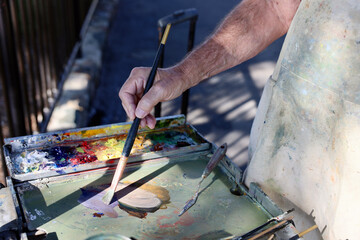professional artist mixing oil paint on the palette,
