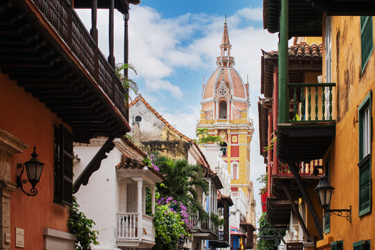 colorful and ancient buildings, walled center of the city of cartagena de indias, sunny day with beautiful blue sky and view towards the cathedral of santa catalina de alejandria.