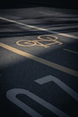 Yellow bicycle icon on the asphalt road