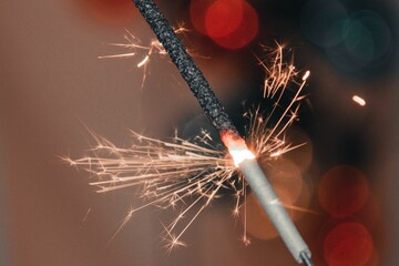 Beautiful view of a sparkler on a blurred bokeh background - Christmas wallpaper