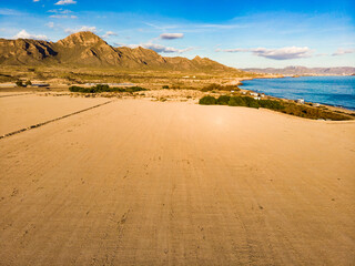 Coast view with campers camping on sea shore, Spain